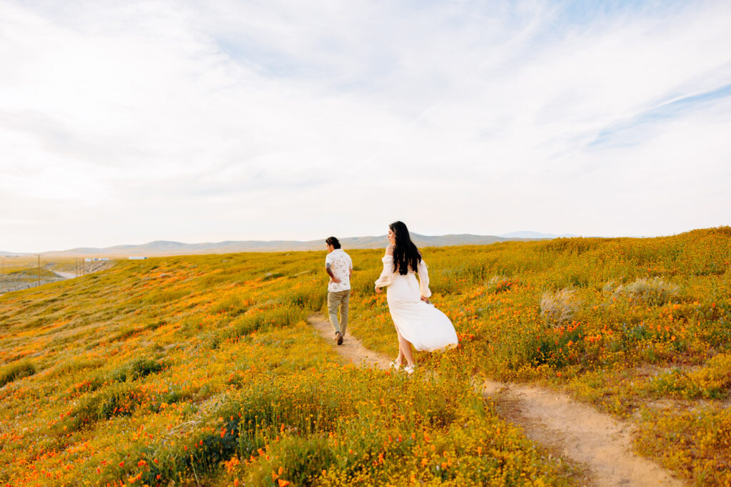 Couple laughing together during sunset engagement photo session in Los Angeles